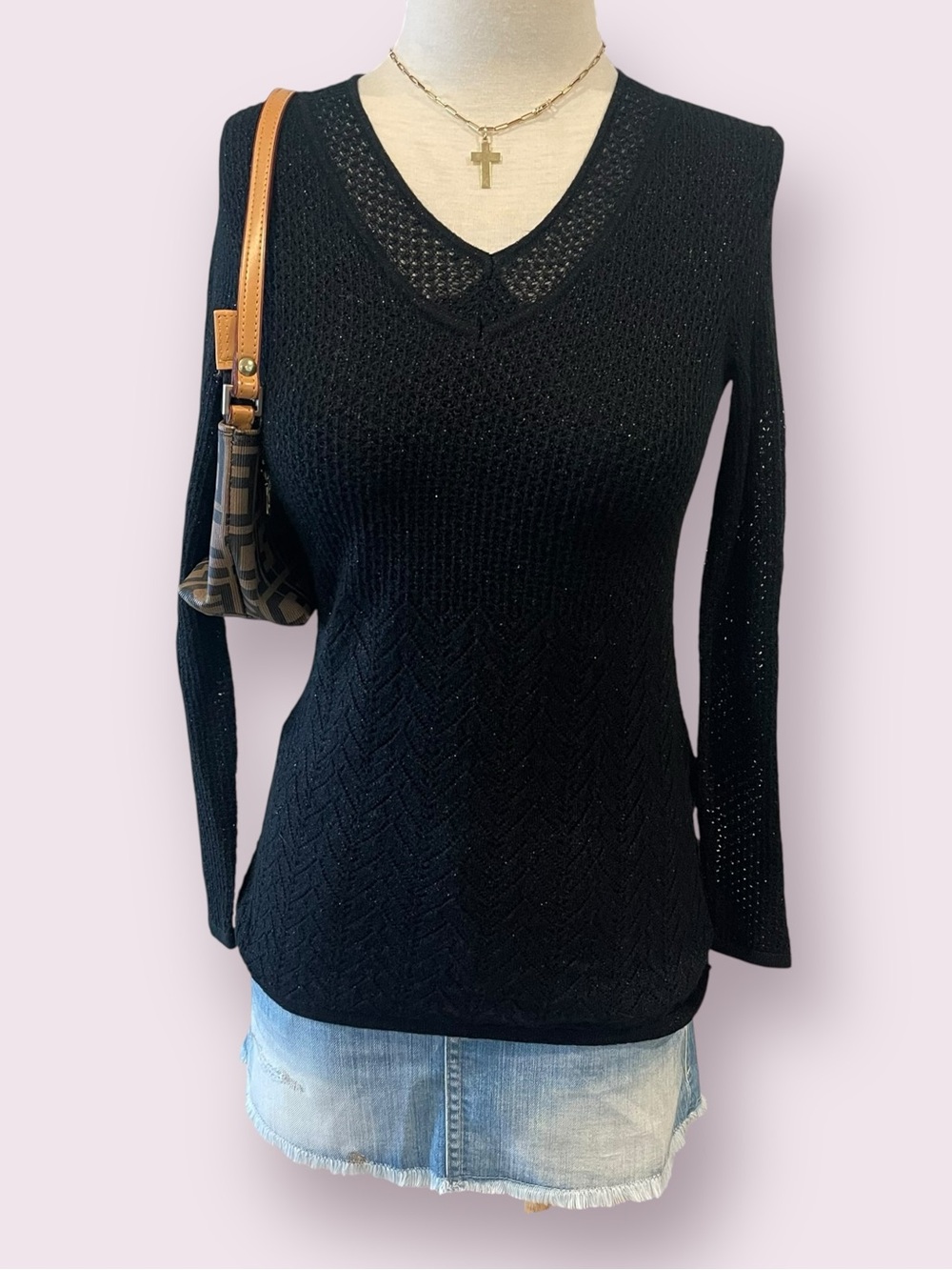 Black knit sweater with textured diamond pattern and sheer sleeves